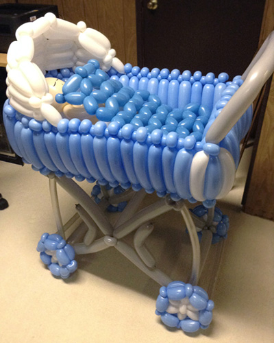 Baby carriage sculpture for shower party